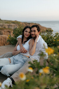 Engagement photos with yellow flowers on the Oregon coast