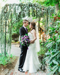 Groom holds Bride at her waist as they look at each other