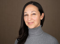 headshot of woman in a gray sweater