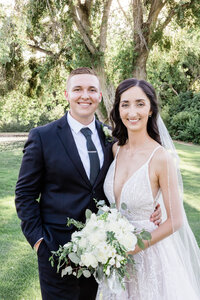 bride and groom posing and smiling