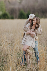 Couple family photo session in field at Fisher Farm Park