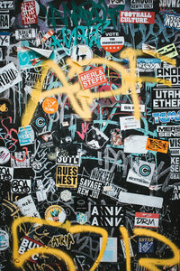 Wall filled with stickers and graffiti