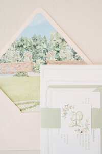 Wedding invitation stack with belly band, monogram, watercolor envelope liner.
