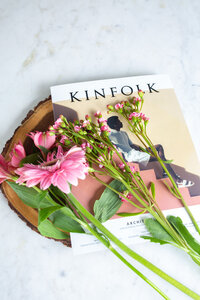 Kinfolk magazine with flowers on top of it