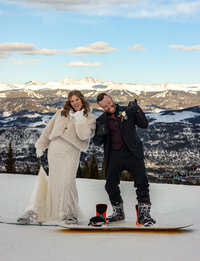 a couple snowboarding for an elopement in Breckenridge Colorado while getting married