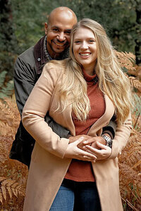 couple holding onto each other and smiling during their engagement photo shoot