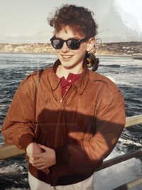 Kelly Loss as a preteen standing on a boat