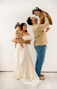 maternity session at Paula Goforth's studio. Mom is dressed in a beautiful two piece dress posing with a boho set up. 