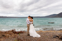 A couple embraces on the lakeshore of Laguna de Apoyo, Nicaragua at their wedding.