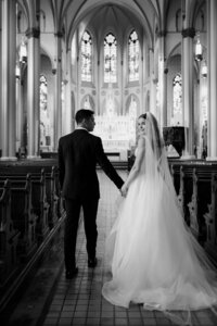 bride and groom holding hands