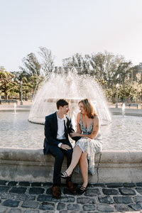 couple sitting on fountain ledge