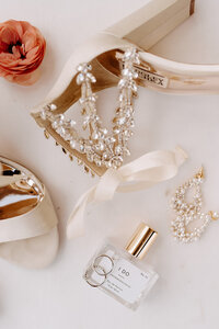 Colorado luxury wedding photographer captures creative wedding day detail shots featuring Anthropologie perfume and wedding ring