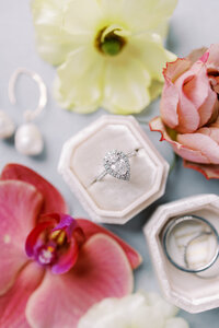 close up detail shot of a wedding ring with ring box and florals at a calgary wedding photographed by Alberta wedding photographers Heidrich Photography
