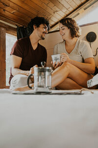 Couple drinking coffee at their Airbnb before their Colorado elopement.