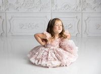 Young girl having fun making silly pose during dream dress photography session 