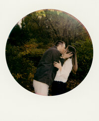 Couple standing under pink tree at the park — captured by a engagement & proposal photographer at Castillo Holliday Photo + Film