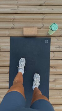 Woman taking photo of her feet before yoga workout