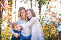 Big hugs for mother from her daughter and son during their fall family photo session