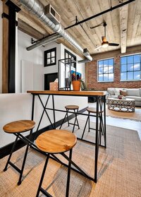 Dining area with seating for four in this three-bedroom, two-bathroom industrial modern loft condo in the historic Behrens building in downtown Waco, TX.