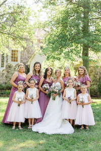A bride poses with her wedding party during her spring time Alabama wedding