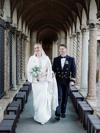 A bride and groom walks together at the Franciscan monastery garden