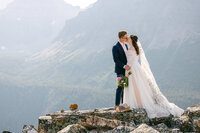 This touching photograph highlights a couple who celebrated their wedding at Moraine Lake, sharing their testimonial for Geoff Wilkings Photography. They praise Geoff’s ability to capture the breathtaking beauty of their special day, from the stunning lake backdrop to the intimate moments, creating memories they will cherish forever.