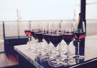 wine glasses filled with red wine sitting on table