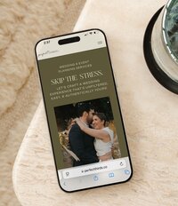 A cellphone with an image of a website designed by Bloem Creations.