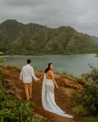 bride and groom walking along beach