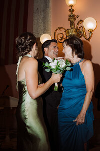 two women dancing with man, groom, at wedding,Documentary wedding photography