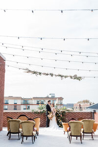 Vintage rugs line the aisle of an outdoor wedding.