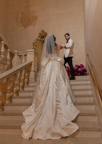 Atop of the famous staircase in New York City's most iconic hotel, The Plaza, the bride and groom shared an intimate first look moment.