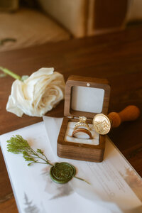 Lake Tahoe cabin wedding details and flat lay shot of wedding ring, flowers and invitations