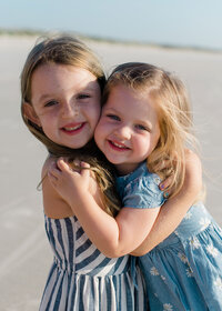 children hug in Jacksonville Florida on the beach