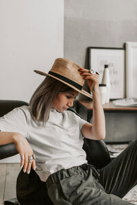 Jessica wearing a white blazer, smiling as she writes in her planner