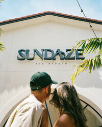 husband and wife wedding photographers in fort myers looking at their studio