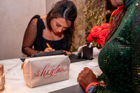 Cat Lauren Calligraphy providing hand-lettering services at an event with SheGLAM