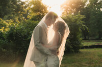 a bride and groom under the veil during golden hour in princeton new jersey