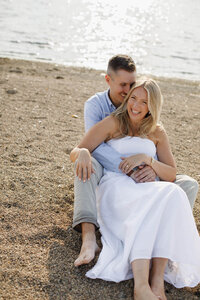 A photo of a couple on a beach posing for a photo 
