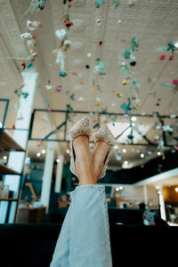 Brooke's feet crossed, in the air.