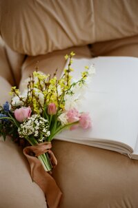 Beautiful wedding bouquet displayed on a sofa.