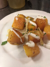 Gourmet squash dish plated on a beautiful hand thrown ceramic plate