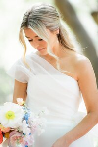 Close up of Bride looking down at her bouquet at El Chorro wedding venue.