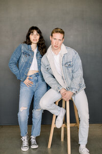 female and male model looking serioulsy into the camera, male sitting on stool and female standing next to him taken by vancouver washington photographers