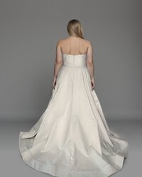 Back view of a midi wedding dress with peplum