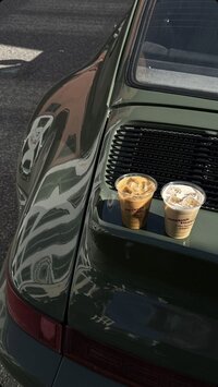 porsche car with two coffees