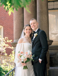 A bride and groom smile for their wedding portrait at their Chicago wedding 