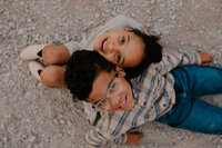 Outdoor family photoshoot in Omaha park during golden hour – capturing candid, heartfelt moments.