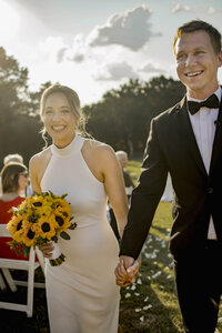a bride and groom smile in the sunshine in plano texas