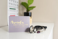 doctor's business card sitting beside a stethoscope